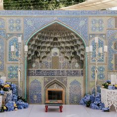 an elaborately decorated room with blue flowers and candles