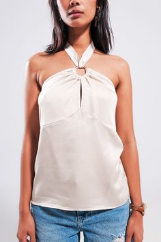 Made in Italy, this glossy satin-style halter top in beige boasts of a cropped length, buckle-and drape detail, a backless and sleeveless design, ring detail, tie back fastenings, and a shiny fabric that is made from 100% Viscose. It’s the perfect top for elevating your casual attire. Consider pairing it with our High Wide Leg Jeans in Light Wash. The model is 5’6” with measurements of 32-24-34 and is wearing a size U. One size fits all. Tan Scarf, Mens Lightweight Jacket, Halter Neck Crop Top, Dressy Sandals, Shiny Fabric, Denim Jacket Men, Neck Crop Top, Mens Skin Care, Loafers For Women