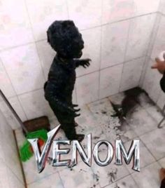 two people standing in a bathroom with the words venom on it