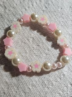 Pink Flower Pearl A bracelet just for your Little girl  to wear a pink flower Pearl bracelet all over the place whevere she goes she will feel like a Pink Flower Trendy Pink Flower Jewelry, White Flower Playful Jewelry, Playful White Flower Jewelry, Playful White Flower-shaped Jewelry, Pink Flower-shaped Bracelet Gift, Sweet Pink Hypoallergenic Jewelry, Sweet White Bracelet Jewelry, Adjustable Pink Flower-shaped Jewelry, Cute Adjustable Pink Jewelry