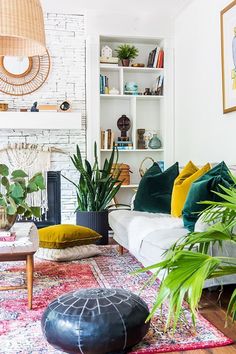 a living room filled with lots of furniture and plants