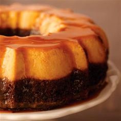 a bundt cake covered in caramel sauce on a white plate