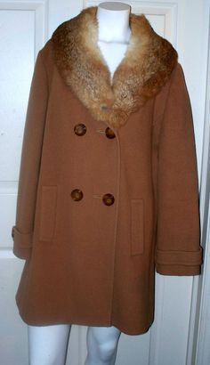 "This is such a lovely vintage rabbit collar beige wool coat. It feels quite thick, so it would be nice and warm. It's lined in beige satin fabric. This is a 3/4 length coat with full length sleeves! The wonderful rabbit collar accents this luxurious wool coat . This is truly a fashion for the ages! Condition: Good. Measurements: Sleeves (shoulder to cuff), 24\" Length: 32.5\" Shoulder-to-Shoulder: 17.5\". Size: Unmarked Brand: Unmarked Material: Wool Body, Mink Collar Closure: Button Front Addi Vintage Brown Long Pea Coat, Vintage Long Brown Pea Coat, Vintage Beige Long Fur Coat, Vintage Long Beige Fur Coat, Vintage Cream Fur Coat With Faux Fur Trim, Cream Vintage Fur Coat For Winter, Vintage Beige Long Sleeve Fur Coat, Brown Vintage Wool Pea Coat, Vintage Brown Pea Coat For Winter