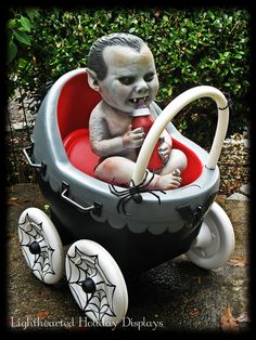 a statue of a baby in a halloween carriage