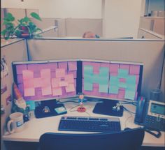 two computer monitors sitting on top of a desk next to a keyboard and monitor screen