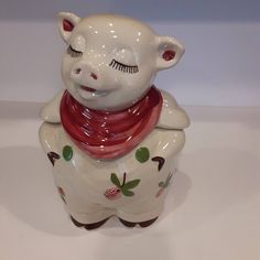 a ceramic pig with a scarf around its neck