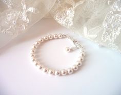 This classic single strand pearl bracelet is perfect for all occasions! ♥ All jewelry comes in a gift box and is ready to give, at no additional cost! ♥ Handmade with: ~Your choice of genuine Swarovski white or ivory/cream pearls (6mm) ~INCLUDES 1/2 INCH EXTENSION for adjustable sizing, embellished with pearl drop ------ ::BRACELET SIZE:: How to measure - Wrap a measuring tape around the wristbone lightly. Add one of the following sizes listed below to your measurement to determine the bracelet Adjustable Pearl Drop Bracelet For Weddings, Cream Pearl Bracelet With Round Beads For Wedding, Classic Silver Pearl Bracelet For Bridesmaids, Adjustable Pearl White Pearl Bracelet For Bridesmaids, Adjustable Beaded Bracelets With Pearl Drop For Bridesmaid, Cream Beaded Bracelets With Round Beads For Wedding, Cream Beaded Bracelets For Wedding With Round Beads, Elegant Adjustable Cream Pearl Bracelet, Adjustable Cream Bracelet For Wedding