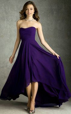 a woman in a purple dress posing for the camera