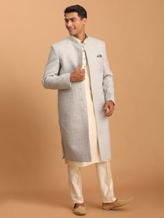 Vastramay Men's Grey Jaccard Sherwani With Cream Kurta Pant Set Make a style statement with this elegant grey jacquard sherwani paired with a cream kurta and pant set. Perfect for weddings and festive occasions, this outfit is crafted with attention to detail and fine craftsmanship. Features: Elegant grey jacquard fabric Cream kurta with intricate design Comes with matching pant Perfect for weddings and festive occasions Specifications: Brand: VASTRAMAY Color: Grey and Cream Material: Jacquard Size: Available in various sizes Material & Care: Jacquard fabric, Dry clean only Legal Disclaimer: The product is guaranteed to be 100% genuine. Product images are for illustrative purposes only. Images/packaging/ labels may vary from time to time due to changes made by the manufacturer's manufactur Classic Fitted Sherwani With Naqshi Detailing, Elegant Sherwani With Chikankari Embroidery For Winter, Elegant Winter Sherwani With Chikankari Embroidery, Classic Sherwani For Groom, Festive Occasion, Classic Sherwani For Groom In Festive Season, Gray Kurta For Wedding And Eid, Elegant Gray Kurta For Eid, Classic Festive Sherwani For Groom, Silver Sherwani For Eid Wedding