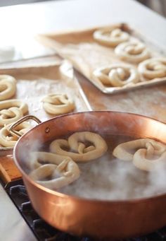 some pretzels are being cooked in a pan on top of the stovetop