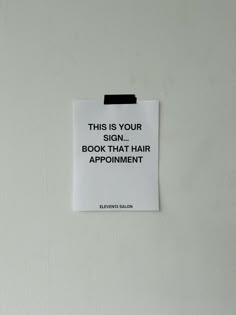 this is your sign, book that hair appointment on a white paper pinned to the wall