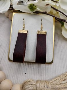 Beautiful, fun genuine leather earrings. Perfect for everyday wear or special occasions. You will love these trendy, genuine leather earrings. Each pair is handmade by us with lead free, stainless steel hooks. They hang at approximately 2.5 inches for the perfect everyday look. All earrings may vary slightly due to leather patterns. Colors may vary slightly due to screen variations. Trendy Brown Rectangular Jewelry, Brown Rectangular Jewelry, Brown Leather Earrings For Gift, Everyday Leather Jewelry In Rectangular Shape, Brown Rectangular Leather Jewelry, Everyday Rectangular Leather Jewelry, Brown Leather Rectangular Jewelry, Handmade Brown Earrings For Everyday Use, Adjustable Drop Earrings For Everyday Use