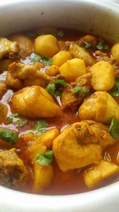 a white bowl filled with food and garnished with cilantro