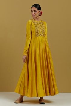 Yellow chanderi anarkali with panelled flare, churidar sleeves, cord detail on neck, hand embroidered yoke in zari and sequin work.
Component: 1
Pattern: Hand Embroidered
Type Of Work: Sequin and Cut dana Work
Neckline: Round
Sleeve Type: Churidar Sleeves
Fabric: Chanderi
Color: Yellow
Other Details: 
Back loop button
Note: The dupatta worn by the model is not for sale
Occasion: Sangeet,Haldi and Mehendi - Aza Fashions Panel Anarkali, Churidar Sleeves, Yellow Anarkali, Silk Anarkali, Indian Dresses Traditional, Anarkali Dress, Kurta With Pants, Designer Dresses Indian, Churidar