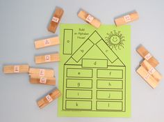 a green paper with some wooden blocks on top of it and letters that spell out the word build