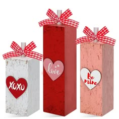 three valentine's day gift boxes with hearts on them and the words love are in red, white, and pink