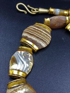 The Rare Unique Bactrian Banded Agate Beads Necklace Circa Late 3RD-EARLY 2ND MILLENNIUM B.C very rare Beads from my Old Collections very rich in patina (rust) Every Bead Got very Big hole The Age of this Beads are more than 2000 Years Old They were used as a special charm Jewelry At that Ancient Times Best gift for the people who collect Ancient Beads and study ancient history Fast and Free Shipping Service World Wide Enjoy Luxury Necklaces With Round Natural Stones, Luxury Necklace With Round Natural Stones, Gold Agate Round Beaded Necklaces, Luxury Agate Gemstone Beads Necklace, Gold Agate Round Beaded Necklace, Gold Agate Beaded Necklaces, Gold Round Agate Beaded Necklaces, Elegant Oval Bead Agate Jewelry, Elegant Agate Jewelry With Oval Beads