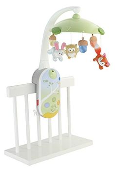 a baby crib with stuffed animals hanging from it