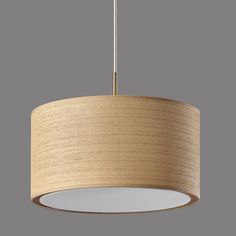 a light that is hanging from a ceiling fixture with a beige fabric shade on it