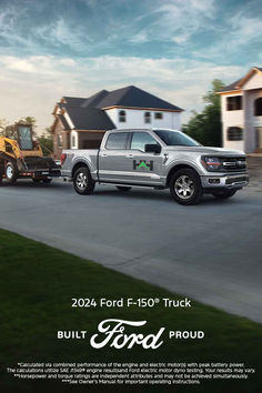 the ford f - 150 truck is being towed by a tractor in front of a house