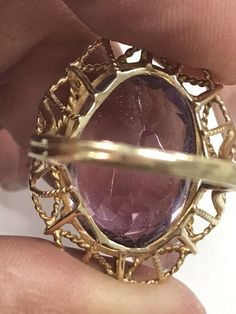 VINTAGE AMETHYST 14K YELLOW GOLD FILIGREE RING Unique and rare design, Fine Oval Amethyst Solitaire Ring approximately 15ct, set in a gorgeous filagree design band. There is a scratch/crack in back of stone. (see pics) Does not go through. It is not really visible from front, I've worn and never noticed until photographing now. Price reflects this. This item is vintage and beautiful that is sure to be one of your favorite pieces! Oval cut Amethyst totaling approximately 15 CTW! Measures approxim Oval Amethyst Gemstones For Formal Occasions, Formal Oval Amethyst Gemstones, Oval Amethyst Ring Stamped 14k, Formal Amethyst Oval Cabochon Ring, Formal Amethyst Oval Cabochon Jewelry, Formal Amethyst Jewelry, Oval Cabochon, Oval Gemstones With Prong Setting For Formal Occasions, Formal Purple Oval Cabochon Jewelry, Oval Cabochon Amethyst Ring For Formal Events