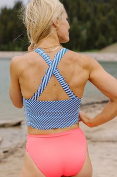 The scalloped detail will have you loving this sporty but feminine design. This crop was our Best-selling top of 2019! It is a bit longer than our other crops and when paired with our high-rise bottoms it gives you the illusion of a one-piece look with the convenience and comfort of a two-piece! You will have a blast Mix and Matching this with all of our bottoms. Due to the large influx of orders with the launch of this new collection, we ask that you allow 3-5 business days for these items to s Crop Swim Top, Athletic Clothing, Workout Clothing, White Leopard, Feminine Design, New Launch, Athletic Outfits, Swim Top, Sports Leggings