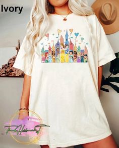 a woman with blonde hair wearing a white t - shirt that has disney characters on it