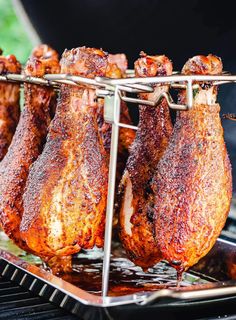 several pieces of meat are being cooked on a grill