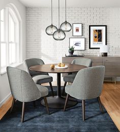 a dining room table with four chairs and an area rug in front of the table