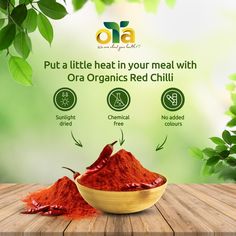 red chilli powder in a bowl on a wooden table with green leaves and the words, put a little heat in your meal with ora organic red chili