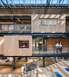 the inside of a building with stairs and people