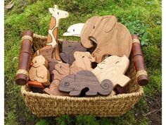 wooden toy animals in a basket on the grass