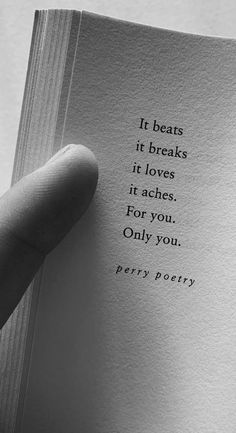 a hand holding an open book with the words it beats it breaks it loves it arches for you only you