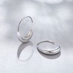 These earrings were designed to add a unique twist to the must-have gold hoop trend. Classic, timeless, and guaranteed to elevate any look. Silver plated Size: 1in x 0.8in Holds safely in the ear Lightweight Hypoallergenic, lead & nickel free If you aren't in LOVE with your purchase, please let us know within 30 days of receiving your item, and you'll receive a stress-free refund. Trendy Silver Hoop Earrings For Formal Events, Trendy Silver Hoop Earrings For Formal Occasions, Modern Silver Teardrop Huggie Earrings, Trendy Sterling Silver Hoop Earrings For Formal Occasions, Silver Hypoallergenic Hoop Earrings For Formal Occasions, Trendy Sterling Silver Hoop Earrings With Ear Wire, Trendy Silver Metal Wrap Earrings, Trendy Sterling Silver Hoop Earrings In White Gold, Trendy White Gold Sterling Silver Hoop Earrings