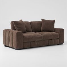 a brown couch sitting on top of a white floor