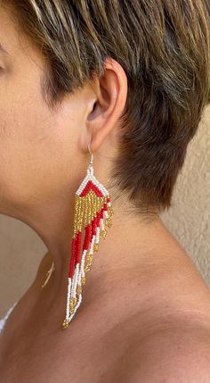 These earrings reflect the cultural traditions of indigenous artisans from Chiapas Mexico. It can take up to an hour to finish every pair. We know you're going to love them as much as we do! They are lightweight and add a pop of color to any outfit. Easy to wear from day to night.  As a special thank you every shipment will receive a FREE GIFT!! Thank you for visiting - Gracias por visitarnos!  Be sure to favorite our shop to get updates on all our new items! Handmade White Chandelier Earrings For Festive Occasions, White Fusion Earrings With Latkans, Festive Handmade White Chandelier Earrings, Traditional White Beaded Earrings With Ear Wire, Traditional White Plug Earrings As Gift, White Beaded Earrings For Festivals Gift, White Beaded Earrings For Festivals And Gifts, Traditional Single Round Bead Earring, Traditional White Beaded Earrings For Gift