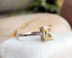 "14K Solid Gold Plain Cushion Yellow Topaz Ring, Alternative Fine Wedding Ring, Elegant Natural Cushion Ring ★ Our ring is adorned with white gold citrine stone and two IVS 1 0.06 ct diamonds. Marriage Proposal, Promise Ring, Reconciliation Gift and Congratulation Gift can be used as a wonderful gift. Can be made in different colors upon request We look forward to meeting you in the minimalist design gift pack ★ If you have any additional questions about this ring, just hit the \"Ask a Question\ Silver Yellow Sapphire Rings For Wedding, Yellow Topaz Sterling Silver Wedding Ring, Yellow Sapphire Gemstone Ring For Wedding, Emerald Cut Yellow Rings For Wedding, White Gold Citrine Topaz Wedding Ring, Radiant Cut Yellow Rings For Wedding, Yellow Emerald-cut Wedding Rings, Classic Yellow Sapphire Wedding Ring, Yellow Sapphire Ring With Accent Stones For Promise