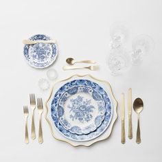 a blue and white table setting with silverware