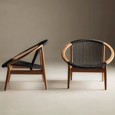 two chairs sitting next to each other on a white floor