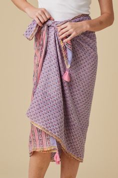 Hand-Block Printed Sarong with Tassels Design Features: Endless styling possibilities: beach cover-up, stylish scarf, or dress Intricate hand-block printed designs Playful tassel accents Material: 100% Cotton Voile Craftsmanship: Crafted with care and attention to detail Bohemian Sarong For Beach Season, Bohemian Cotton Sarong For Beach Season, Bohemian Cotton Sarong For Beach, Bohemian Patterned Sarong For Summer, Bohemian Cotton Sarong For Summer, Bohemian Cover-up With Back Tassel Tie-up, Bohemian Patterned Sarong For Vacation, Bohemian Patterned Sarong For Beach, Bohemian Pink Sarong For Vacation