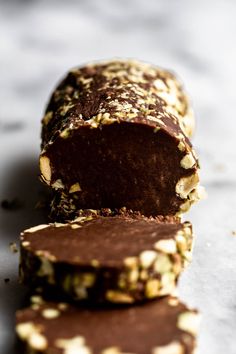 two pieces of chocolate with nuts on top