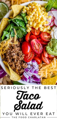 a bowl filled with taco salad next to tortilla chips