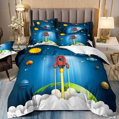 a bed room with a neatly made bed and a night sky scene on the comforter