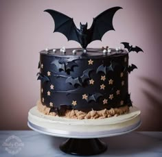 a black cake with stars and bats on it