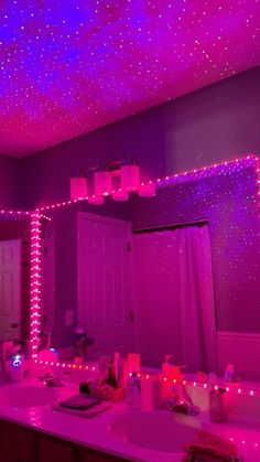 the bathroom is decorated with purple lights and stars on the ceiling, along with other decorations