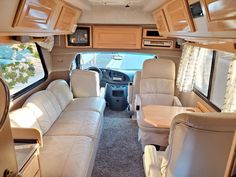 the interior of an rv with couches and tables