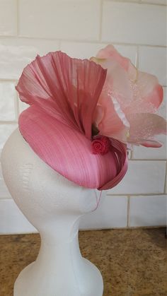 This bespoke design of the back view of large rose in a mist ; looks great from all sides hand blocked on my large wooden approx 18 cm base I hold lots of different  items in stock  Abaca silk,  sinamay silk, feathers,  premier haute  sinamay ,  lots of silk flowers ( that is were the florist in my comes alive i get carried away when i go shopping for new stock) feathers beads, brooch, silk ribbons, organza to make my hand sewn roses. & lots more. I will be happy to take orders just email me  pa Handmade Pink Fascinator For Wedding, Rose Wedding Fascinator With Handmade Flowers, Wedding Hats, Bespoke Design, Silk Ribbon, Go Shopping, Silk Flowers, Hats For Women, Wedding Accessories