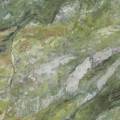 green marble with white and brown streaks on it's surface is seen in this image