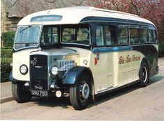 an old bus is parked on the side of the road