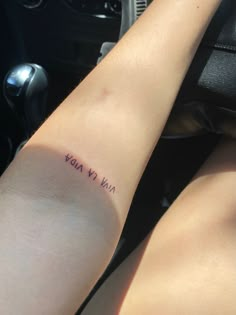 a woman's arm with the word stay wild written in cursive font